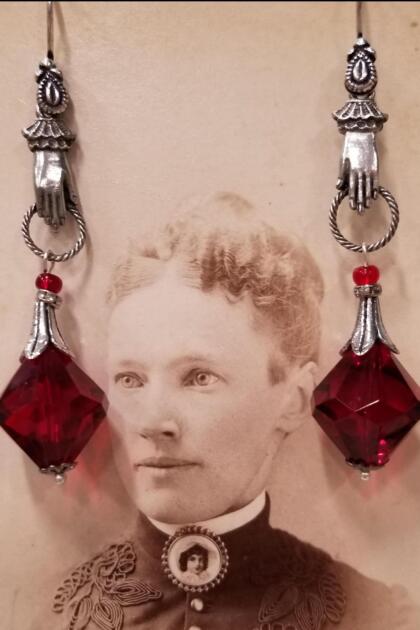 Hands with Red Gem Earrings